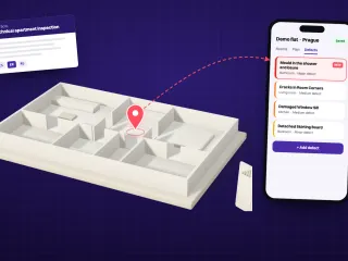 A clay model of the flat with a red pin in the bathroom, tied to the inspector's phone where the new defect has just been logged